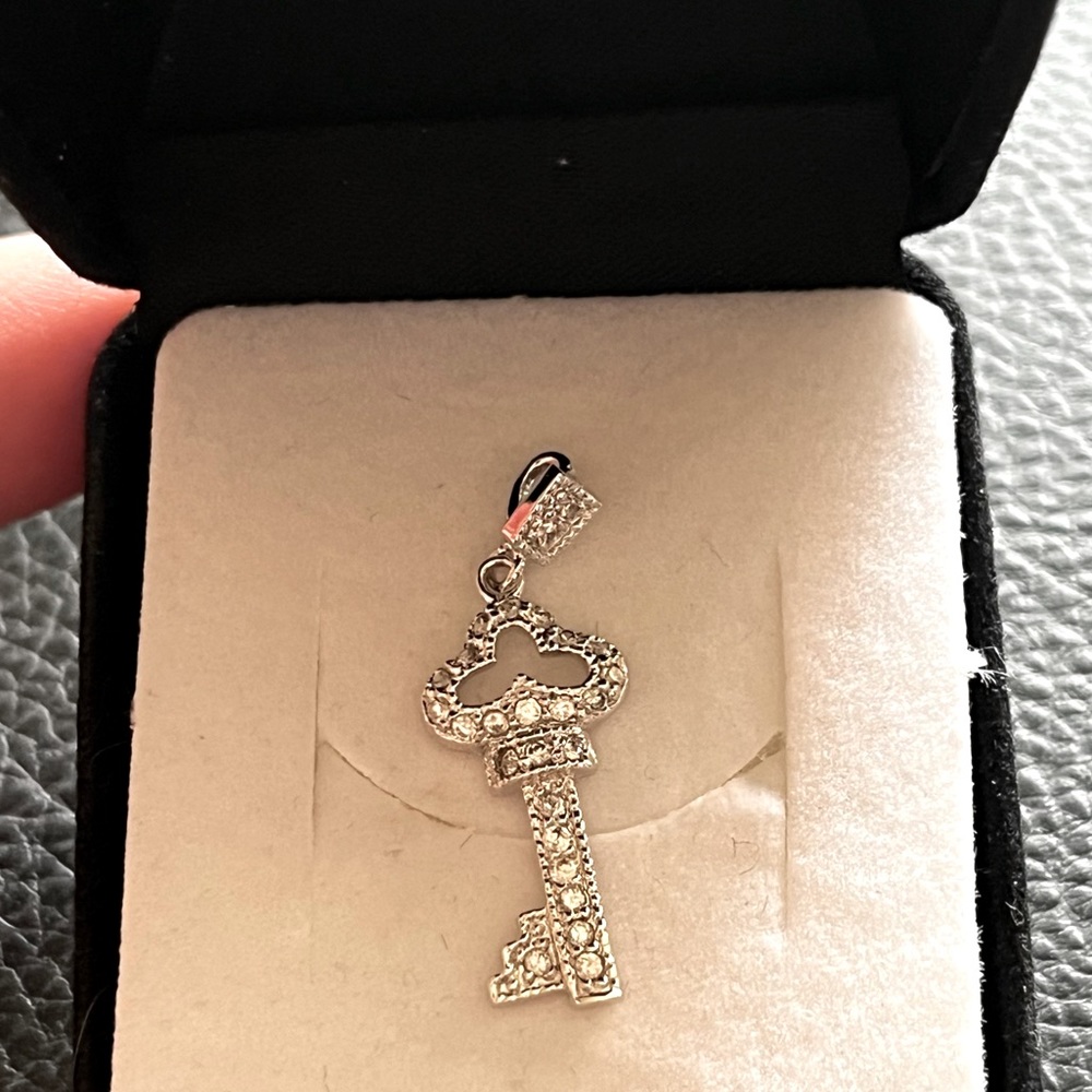 Sterling silver pendant. Key with white stones. Stamped.
